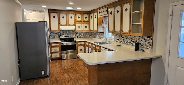 kitchen featuring under cabinet range hood, appliances with stainless steel finishes, a peninsula, and light countertops