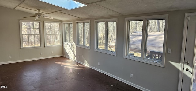 unfurnished sunroom with lofted ceiling with skylight, visible vents, and a ceiling fan