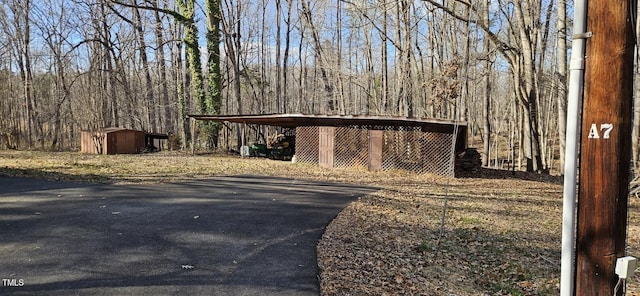 view of shed featuring a wooded view