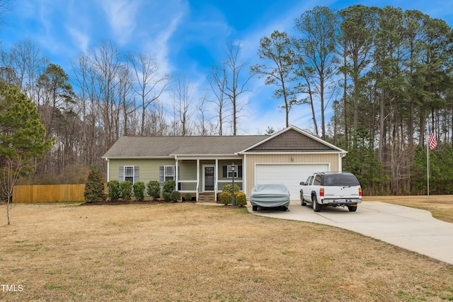 ranch-style house with driveway, a front lawn, fence, covered porch, and a garage