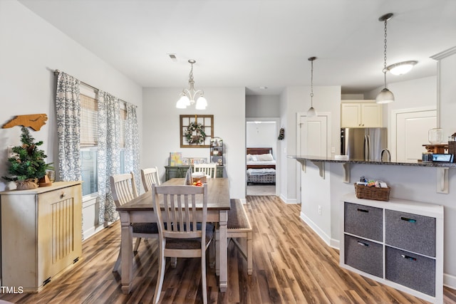 dining room with visible vents, baseboards, a chandelier, and light wood finished floors