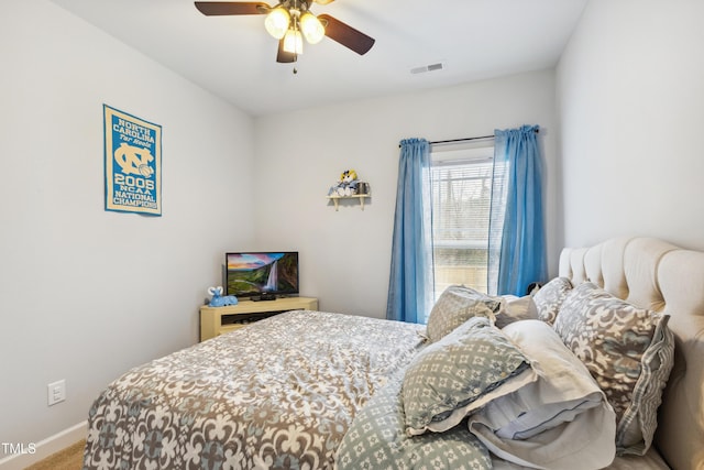 carpeted bedroom with baseboards, visible vents, and ceiling fan