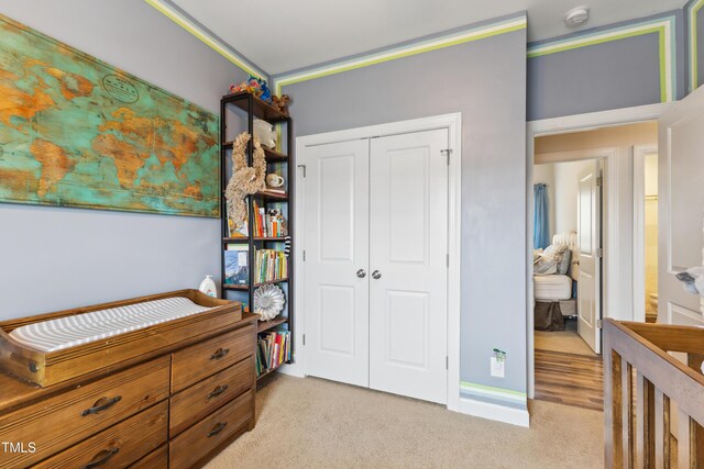 bedroom featuring a closet and light carpet