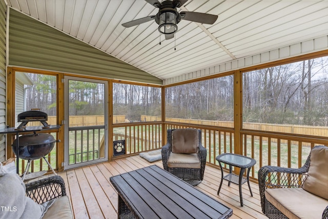 sunroom / solarium featuring a wealth of natural light, ceiling fan, and vaulted ceiling