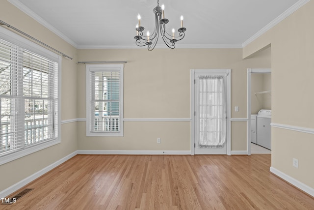 unfurnished room with washer and dryer, baseboards, wood finished floors, and crown molding