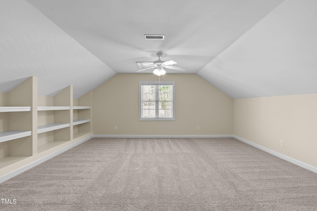 bonus room with built in features, carpet, visible vents, baseboards, and lofted ceiling