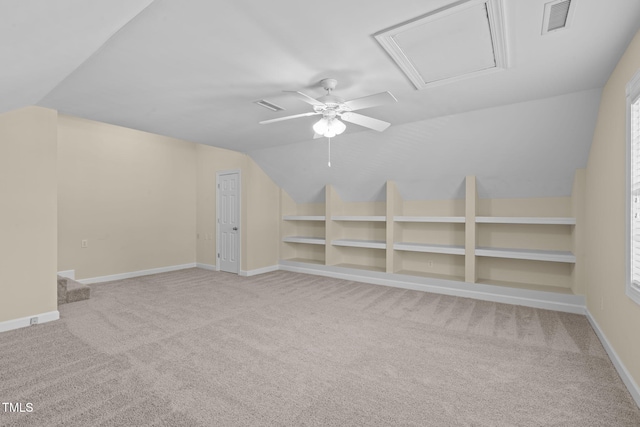 additional living space featuring carpet flooring, built in shelves, and visible vents