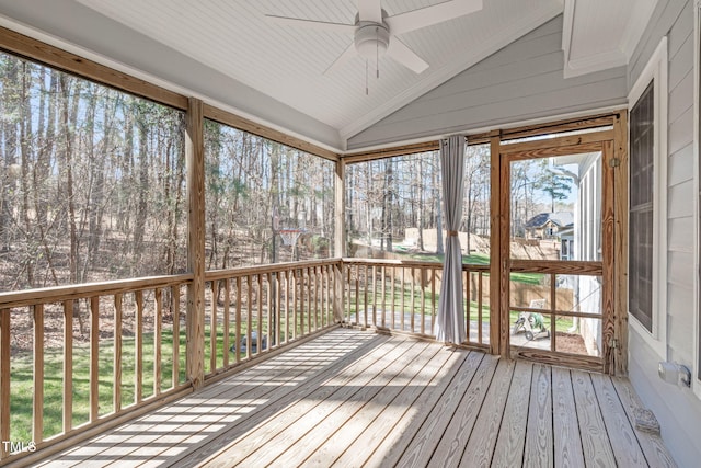 unfurnished sunroom with lofted ceiling, plenty of natural light, and ceiling fan