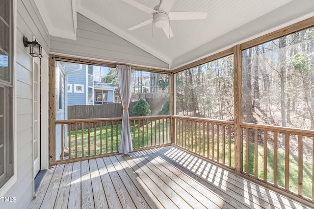 unfurnished sunroom featuring vaulted ceiling and a ceiling fan