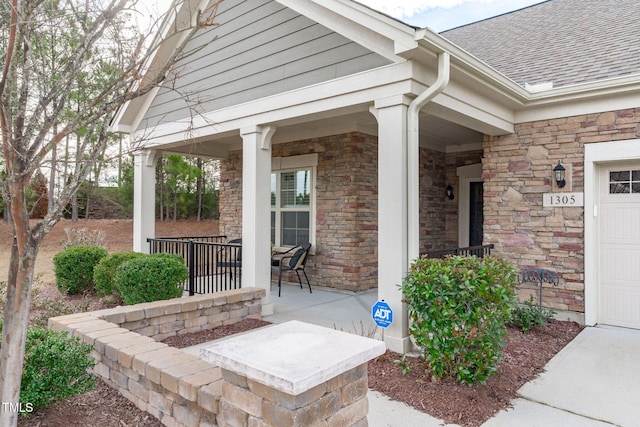 view of patio with a porch and a garage