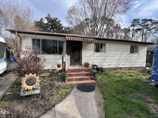 ranch-style home featuring crawl space and a front yard