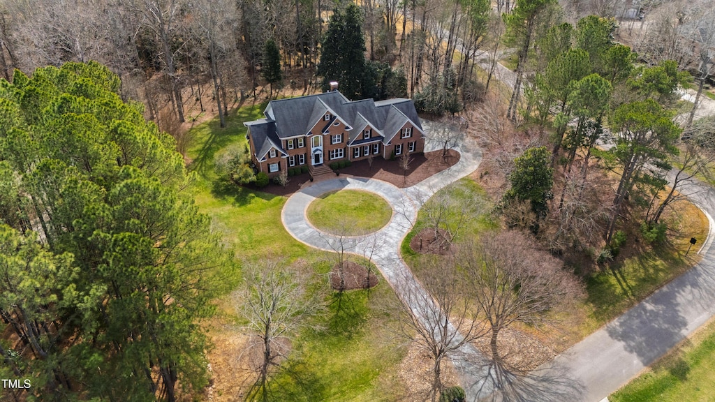 birds eye view of property featuring a view of trees