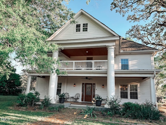 greek revival house featuring a balcony and a porch