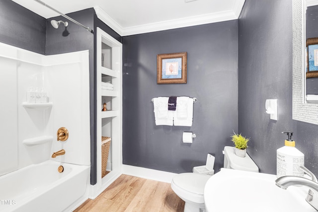 full bathroom with crown molding, toilet, wood finished floors, and a sink