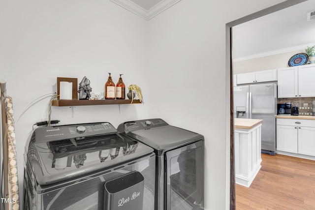 laundry area featuring visible vents, washer and dryer, light wood-style floors, crown molding, and laundry area