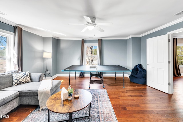 interior space with visible vents, crown molding, ceiling fan, and wood finished floors