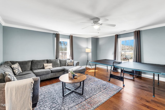 living room with plenty of natural light, wood finished floors, and ornamental molding