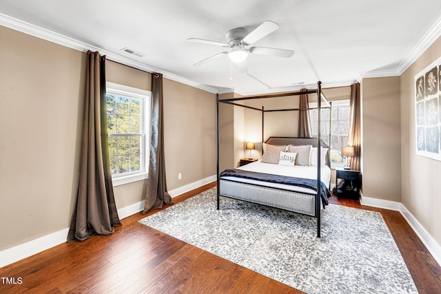 bedroom with baseboards, dark wood-style floors, visible vents, and ornamental molding