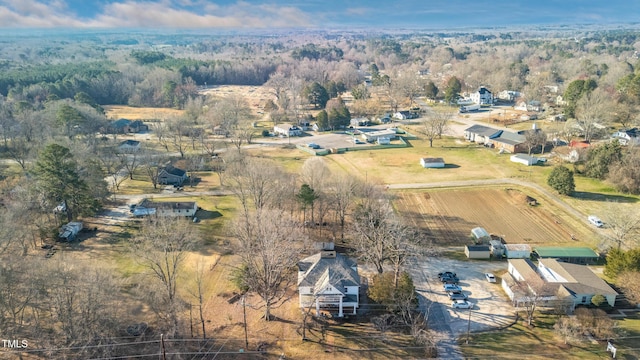 birds eye view of property with a forest view