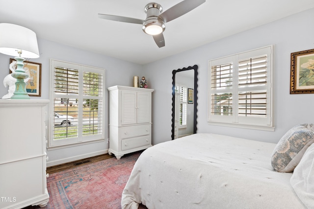 bedroom featuring visible vents, wood finished floors, baseboards, and ceiling fan