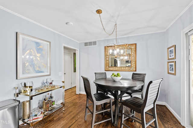 dining area with visible vents, ornamental molding, and dark wood finished floors