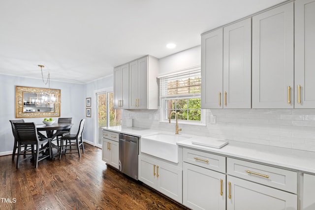 kitchen featuring a sink, plenty of natural light, tasteful backsplash, dishwasher, and dark wood-style flooring