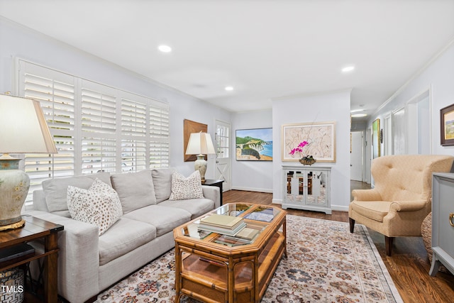 living area with recessed lighting, wood finished floors, baseboards, and ornamental molding