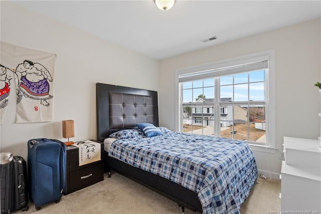 bedroom with visible vents and light colored carpet