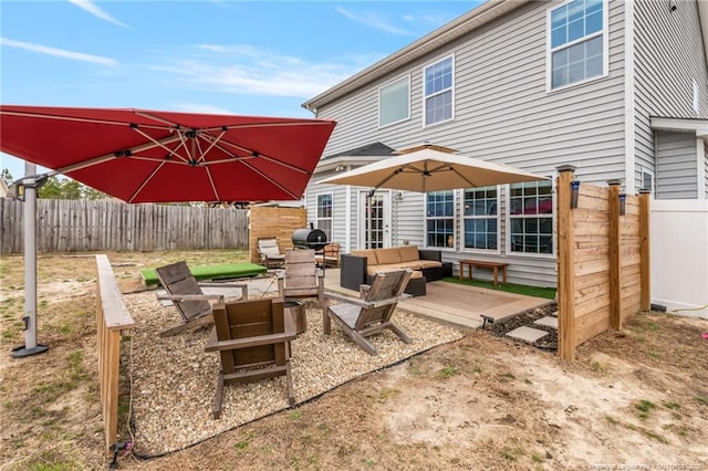 view of patio with an outdoor hangout area, area for grilling, and a fenced backyard