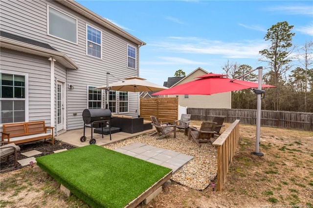 view of yard featuring a patio area, an outdoor living space with a fire pit, and fence