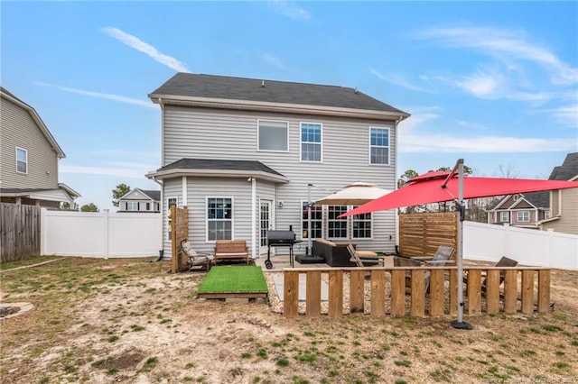 back of house featuring a fenced backyard