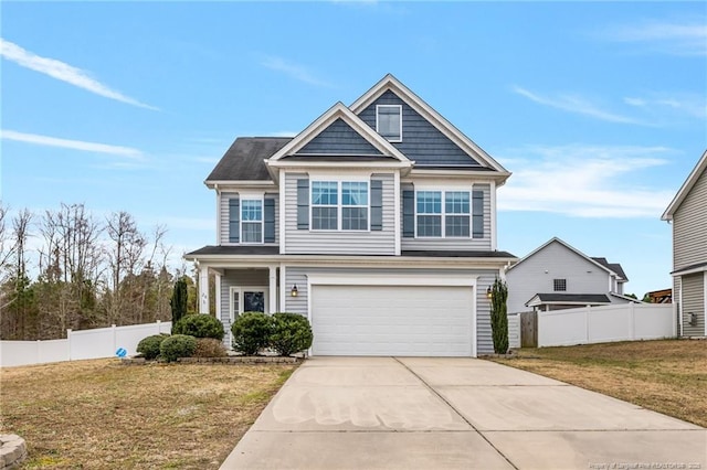 view of front facade with a front lawn, concrete driveway, a garage, and fence