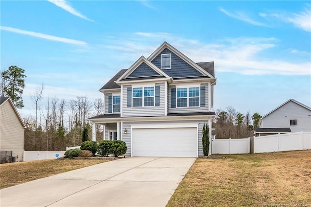 view of front of property with a front yard, fence, a garage, and driveway