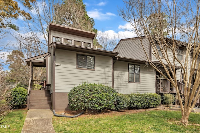 view of side of home with a yard