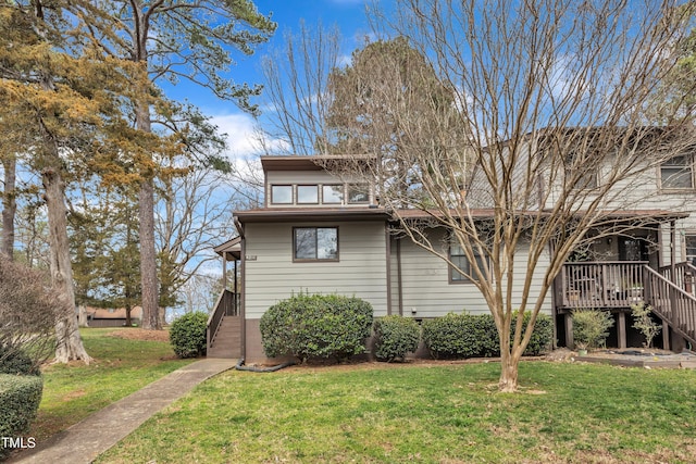 view of front of home with stairway and a front lawn