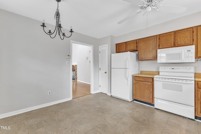 kitchen featuring brown cabinets, ceiling fan with notable chandelier, white appliances, light countertops, and baseboards