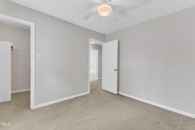 unfurnished bedroom featuring baseboards, carpet, and ceiling fan