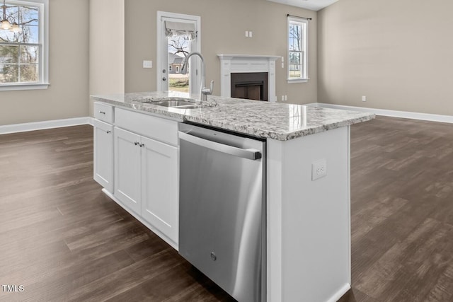 kitchen featuring a sink, white cabinets, light stone countertops, and stainless steel dishwasher