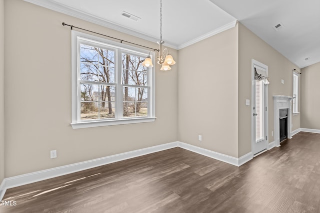 unfurnished dining area featuring visible vents, baseboards, dark wood finished floors, a fireplace, and an inviting chandelier