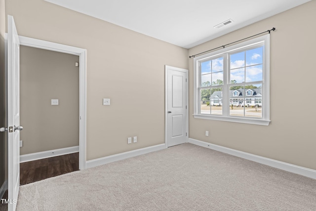 unfurnished bedroom featuring visible vents, carpet flooring, and baseboards