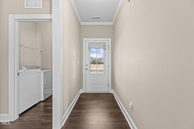 entryway with visible vents, dark wood-style floors, crown molding, and washer and clothes dryer