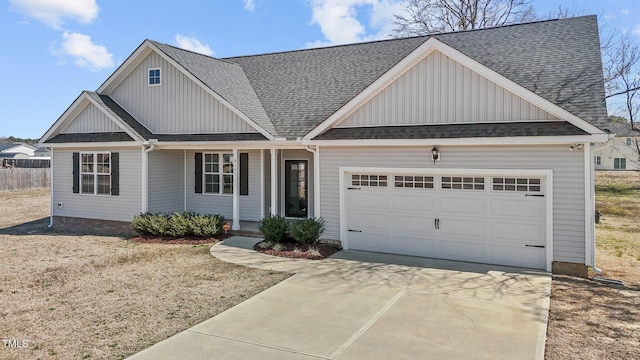 view of front of home with a garage, board and batten siding, driveway, and a shingled roof