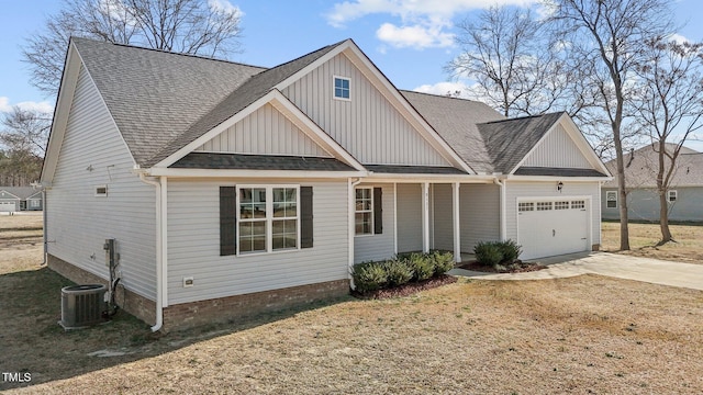 view of front facade with concrete driveway, an attached garage, central AC, and roof with shingles