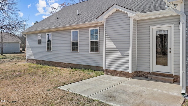 rear view of property with a patio, roof with shingles, and entry steps