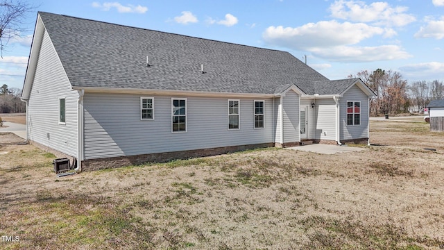 rear view of property featuring roof with shingles