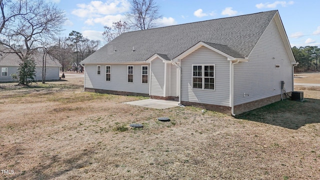 rear view of house with roof with shingles