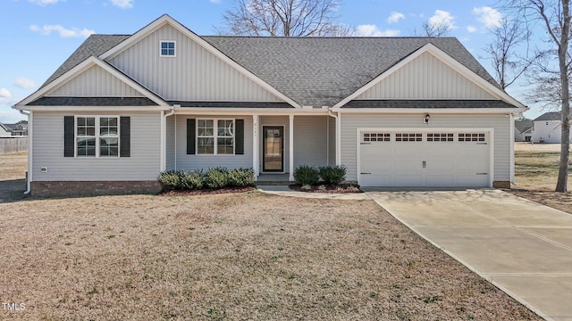 view of front facade featuring concrete driveway, an attached garage, board and batten siding, and roof with shingles