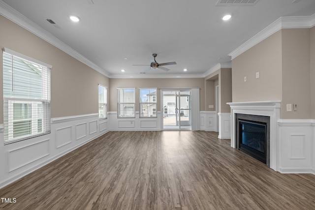 unfurnished living room with a glass covered fireplace, recessed lighting, visible vents, and wood finished floors