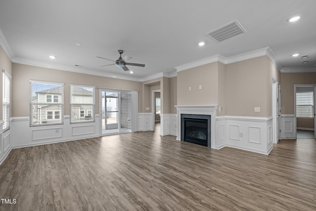 unfurnished living room with wood finished floors, recessed lighting, a fireplace, and visible vents