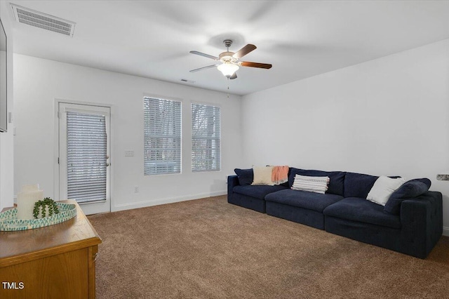 carpeted living room featuring visible vents, baseboards, and a ceiling fan